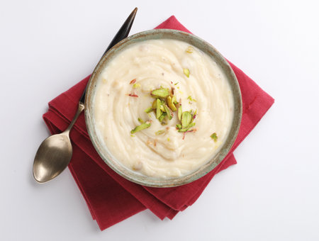 Shrikhand is an Indian sweet dish made of strained curd,garnished with dry fruits and saffron. Served in a ceramic bowl.Selective focusの写真素材