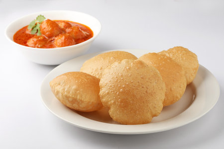 Indian food puri with potato curry on white plate.の写真素材