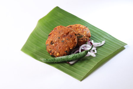 Tea time snack, Dal Vada on banana leaf   or Parippu Vada or Paruppu Vadai , deep fried snacks savory food from Kerala fried in coconut oil. banana leafの写真素材