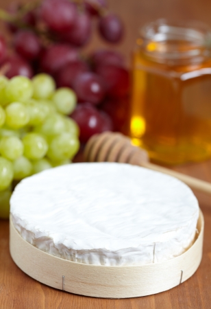Brie cheese on a wooden boardの写真素材