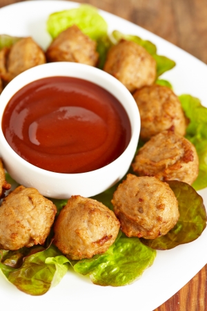 Meatball appetizers with a dipping sauceの写真素材