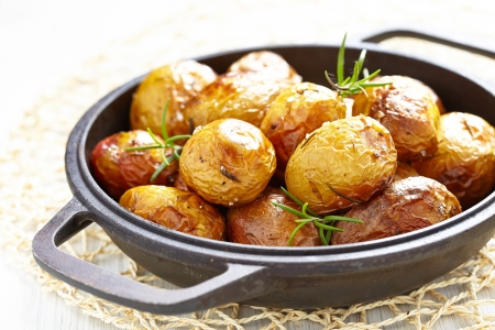 Baked potatoes with rosemaryの写真素材