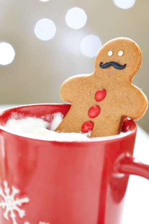 Gingerbread cookie men in a hot cup of cappuccinoの写真素材