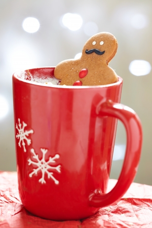 Gingerbread cookie men in a hot cup of cappuccinoの写真素材