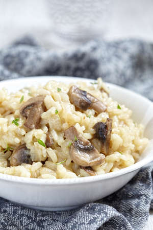 Bowl of mushroom risotto garnished with thymeの写真素材