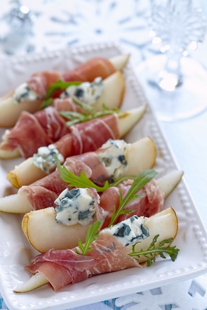 Appetizer with pear, prosciutto and blue cheese for holidaysの写真素材