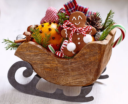 Christmas sleigh with gingerbread man and orangesの写真素材