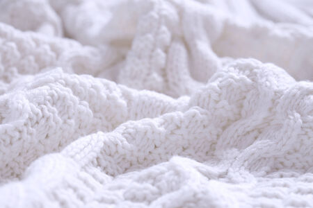 Closeup of white wool coiled rope cable knitting stitch backgroundの写真素材