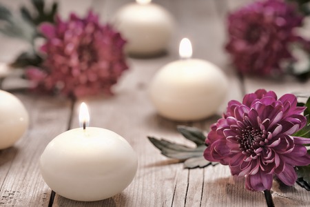 Spa theme with candles and flowers on wooden backgroundの写真素材
