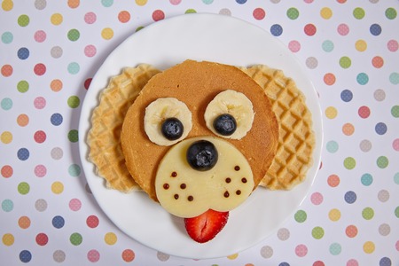 Funny dog pancake with berries for kids breakfastの写真素材