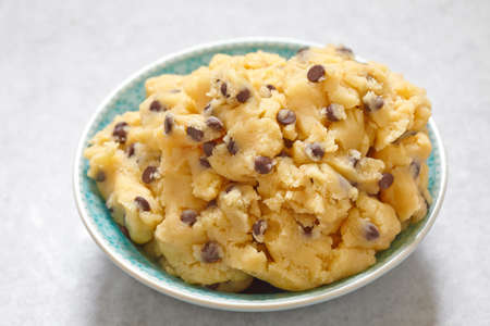 Sweet cookie dough with chocolate chips on a table