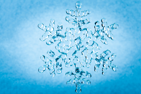 Christmas decoration. Beautiful snowflake on blue background