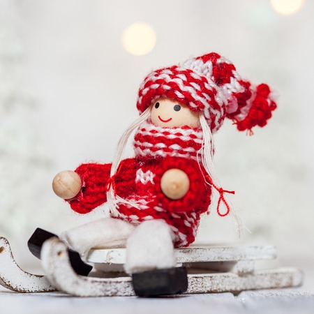 Christmas girl doll toy on a sleigh for decorationの写真素材