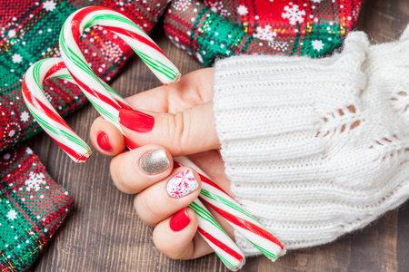 Christmas Nail art manicure. Winter Holiday style bright Manicure with gems Christmas tree and snowflakesの写真素材