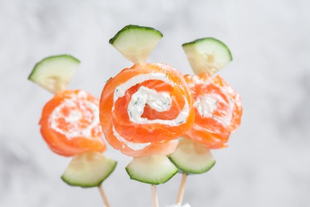 Smoked salmon rolls with cream cheese and cucumber candyの写真素材