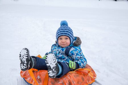 Winter fun, snow, sledding at winter timeの写真素材