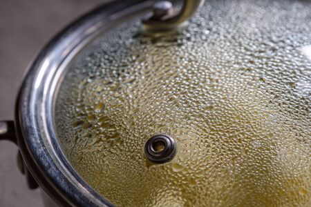 cooking in pot pan with cover on stoveの写真素材