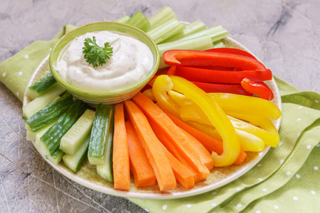 Platter of assorted fresh vegetables with dipの写真素材