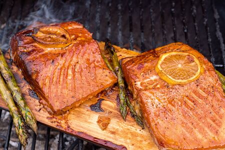 cedar plank salmon with lemon on a grillの写真素材