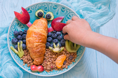 Croissant with berries for funny kids breakfastの写真素材