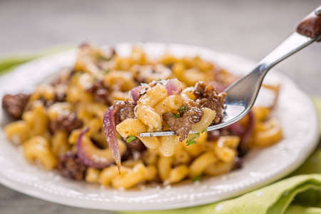 tasty cellentani pasta with meat sauceの写真素材