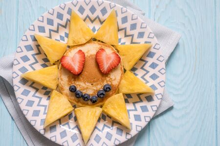Funny pancakes with berries for kids breakfastの写真素材