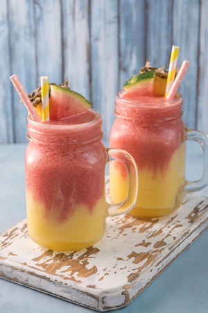 tropical watermelon pineapple slush smoothie in mason jarの写真素材