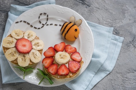 Flowers pancakes with bee for kids breakfastの写真素材