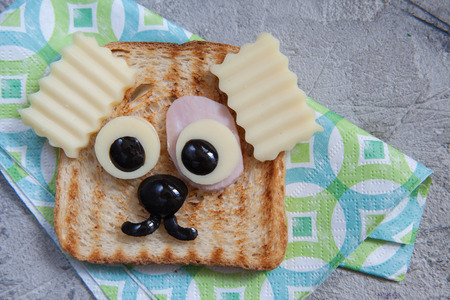 Funny dog and cat sandwich for kids lunch on a table.の写真素材