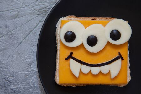 Funny monster sandwich for kids lunch on a table. Halloween foodの写真素材