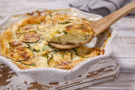Low carb Green Zucchini casserole with cheese in baking dishの写真素材