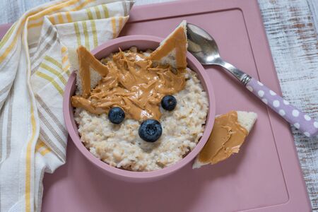 Kids breakfast porridge with fruits and nutsの写真素材