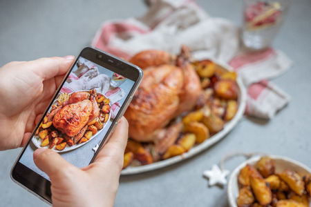Whole roasted chicken with potatoの写真素材