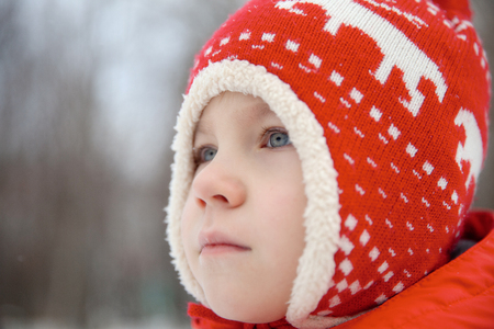 Winter portrait of kid boy in colorful clothesの写真素材