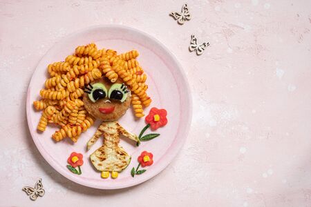 Funny Girl Food Face with Cutlet, Pasta and Vegetablesの写真素材