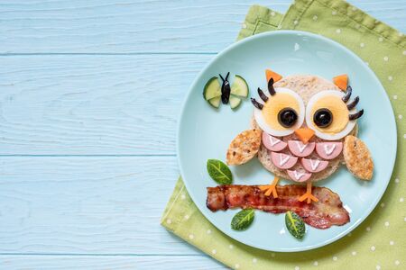 Cute little owl sandwich toast with sausages and eggsの写真素材