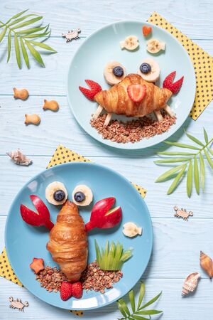 Fun Food for kids. Cute crab and lobster croissants with fruit for kids breakfastの写真素材