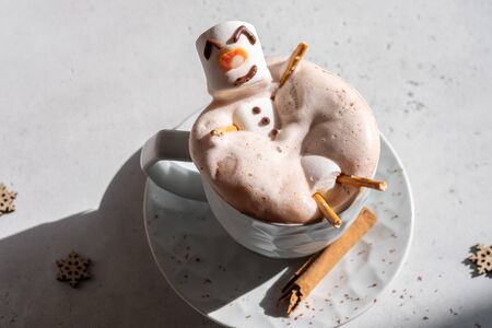 Hot chocolate with melted marshmallow snowmanの写真素材