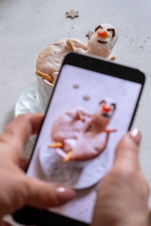 Hot chocolate with melted marshmallow snowmanの写真素材