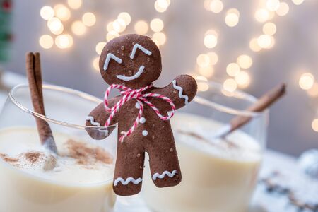 Traditional Christmas drink eggnog with cinnamon and Gingerbread man cookiesの写真素材