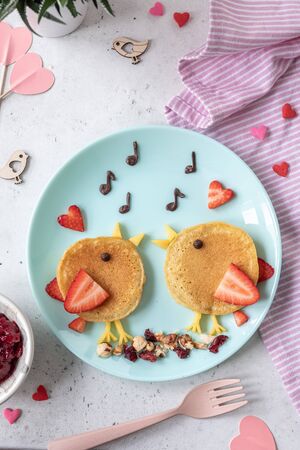 Creative idea for kids breakfast - funny pancakes shaped cute birdsの写真素材