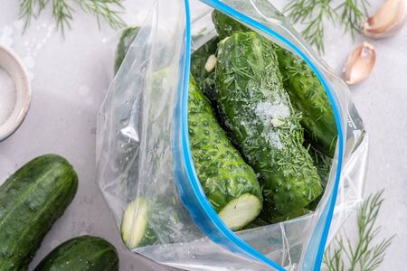 Salted, crunchy cucumbers with dill and garlic in a bagの写真素材