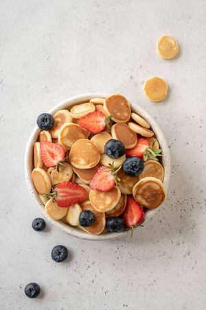 Pancake cereal in a bowl with strawberry and blueberryの写真素材