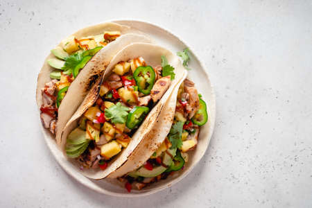 Tortillas filled with chicken and topped with pineapple salsaの写真素材