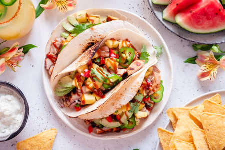 Tortillas filled with chicken and topped with pineapple salsaの写真素材