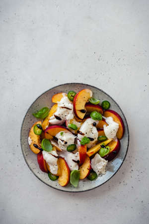 Fresh Summer Salad with Peaches and Buratta Cheeseの写真素材