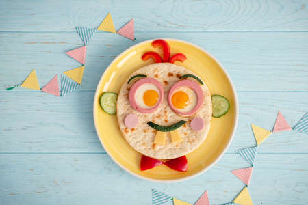 Funny breakfast for kids with face shape sandwichの写真素材