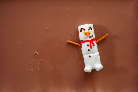 Hot chocolate with melted marshmallow snowmanの写真素材