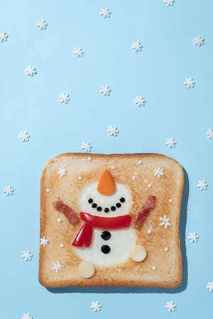 Christmas breakfast: toast with egg white in the shape of snowman