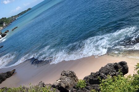 Rocky coast of island Bali about a temple of Uluwatuの写真素材